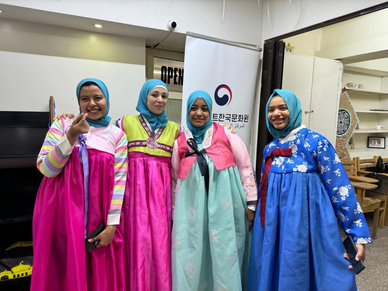 A group of women wearing dresses

Description automatically generated